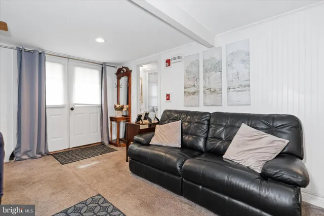 a bedroom with a bed table chair and a window