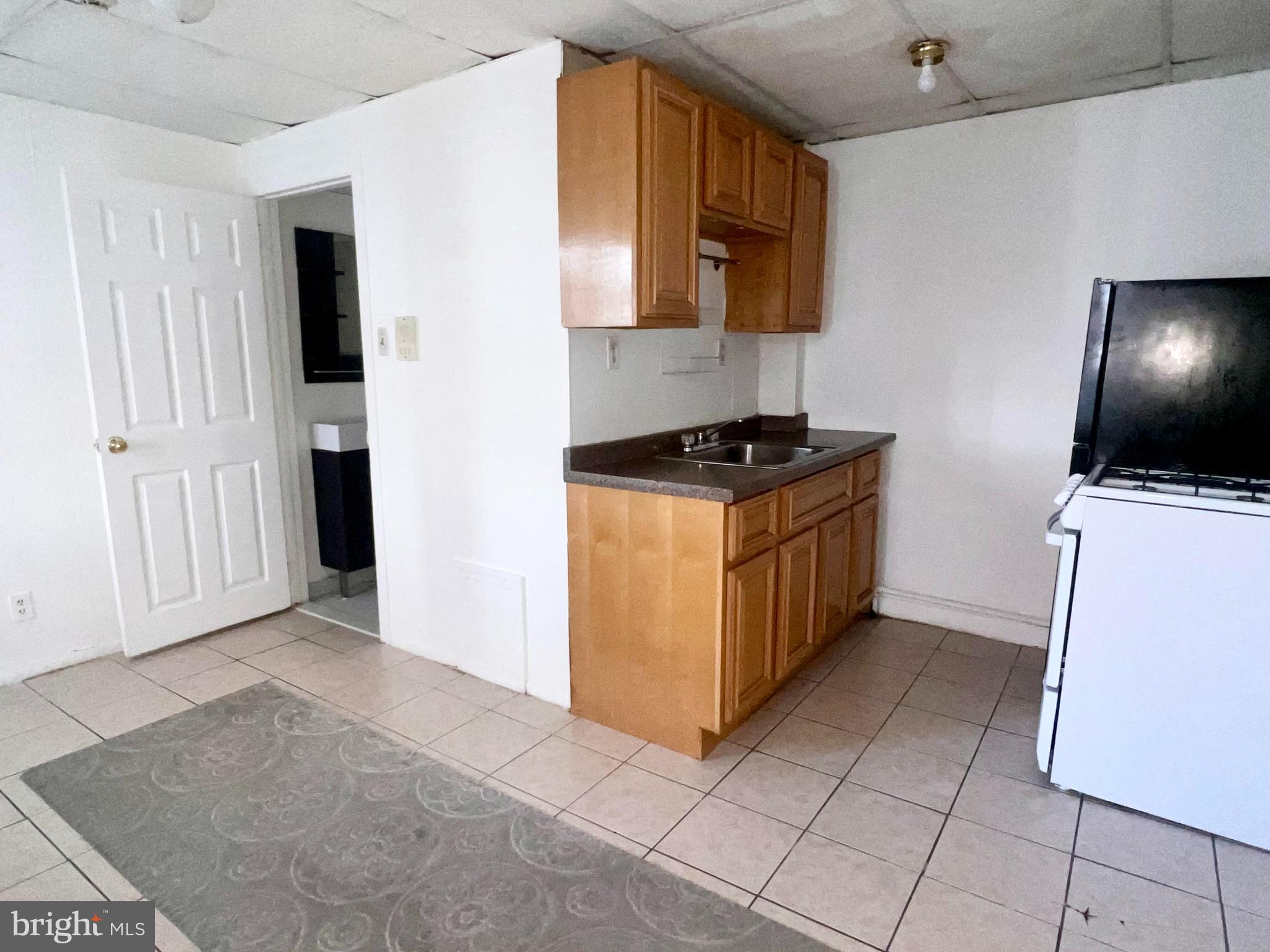 1247 Shackamaxon Street, Unit 2R Philadelphia, PA 19125 - Photo 5 of 12 a kitchen with stainless steel appliances a stove a microwave and a refrigerator