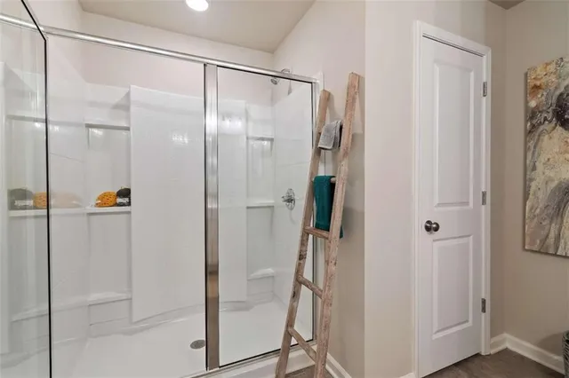a bathroom with a glass shower door