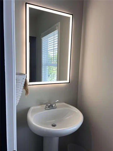 a bathroom with a sink and a window