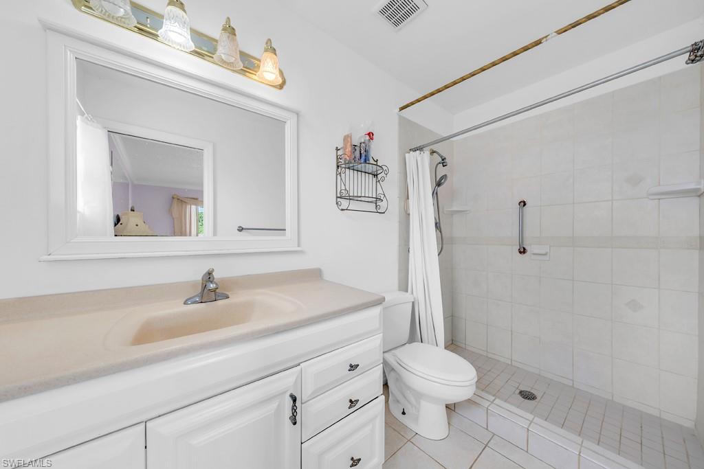 4736 25th Avenue Southwest Naples, FL 34116 - Photo 11 of 26 a bathroom with a sink a toilet and shower