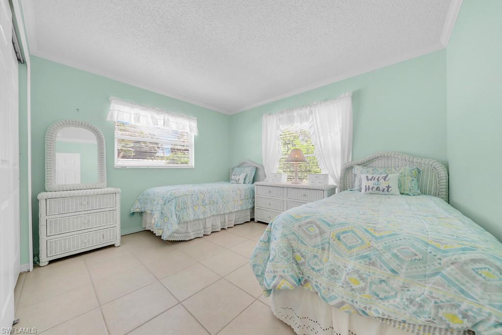 4736 25th Avenue Southwest Naples, FL 34116 - Photo 13 of 26 a bedroom with a bed and window