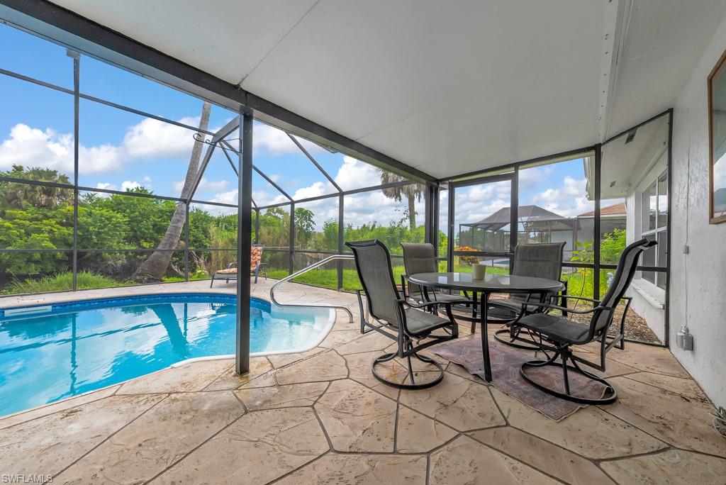4736 25th Avenue Southwest Naples, FL 34116 - Photo 17 of 26 a view of a work space with furniture and floor to ceiling window