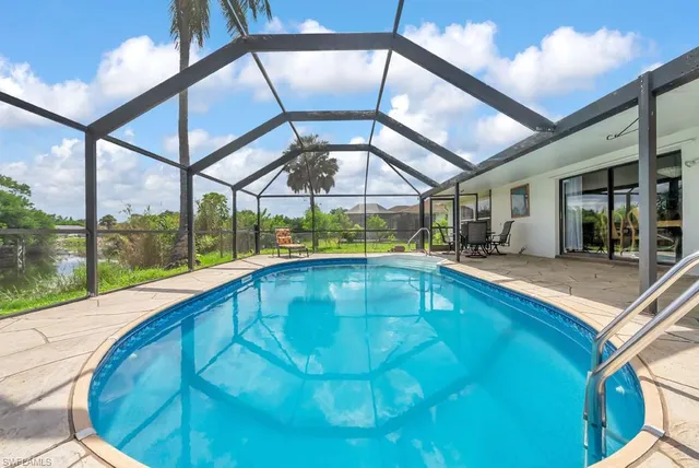 a swimming pool with outdoor seating and yard