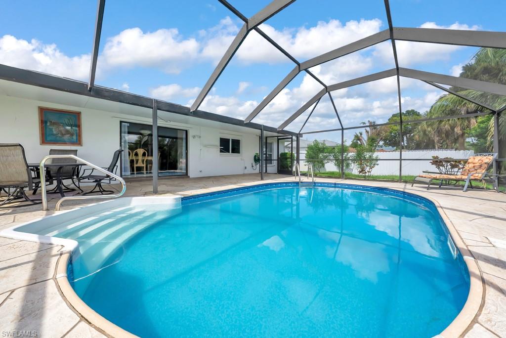 4736 25th Avenue Southwest Naples, FL 34116 - Photo 22 of 26 a swimming pool with outdoor seating and yard