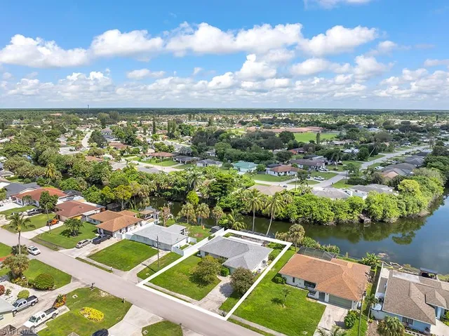 an aerial view of residential building and lake