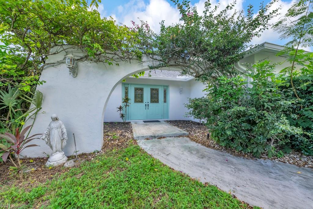 4736 25th Avenue Southwest Naples, FL 34116 - Photo 3 of 26 a front view of a house with garden