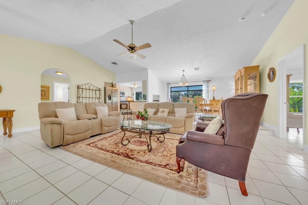 4736 25th Avenue Southwest Naples, FL 34116 - Photo 5 of 26 a living room with furniture and a chandelier