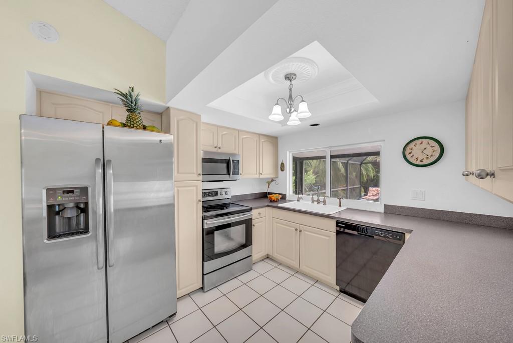 4736 25th Avenue Southwest Naples, FL 34116 - Photo 8 of 26 a kitchen with stainless steel appliances a refrigerator sink and stove