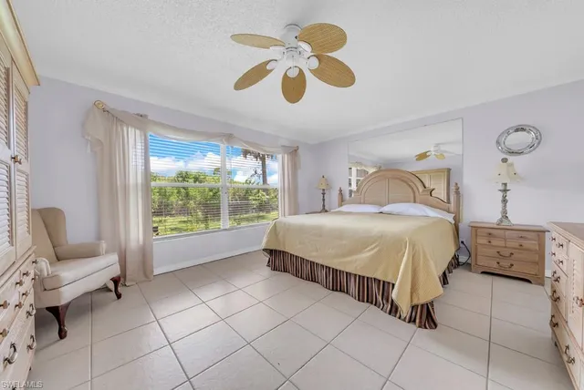 a bedroom with a bed dresser and a window