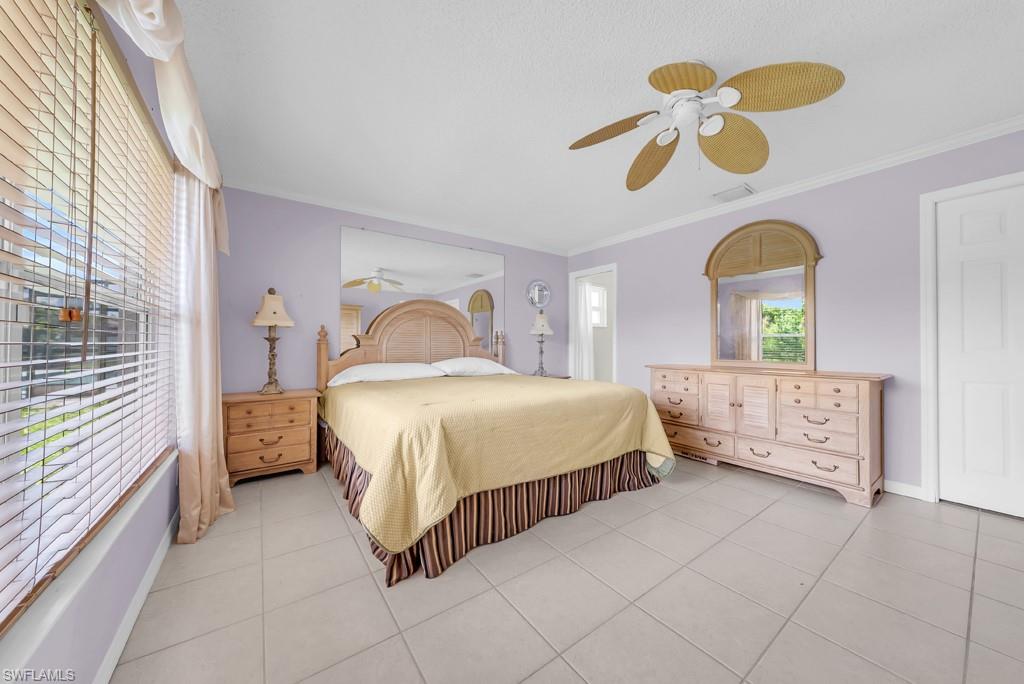 4736 25th Avenue Southwest Naples, FL 34116 - Photo 10 of 26 a bedroom with a bed dresser and a window