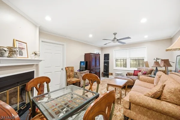 a living room with furniture a fireplace and a large window