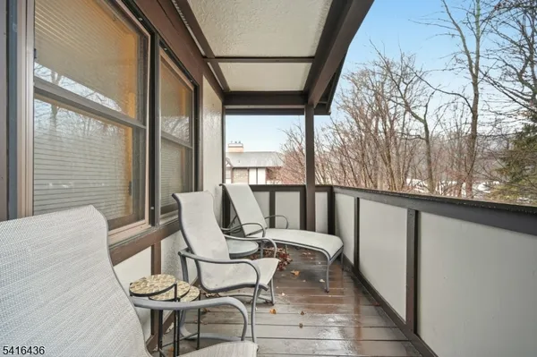 a view of a chairs and table in the balcony