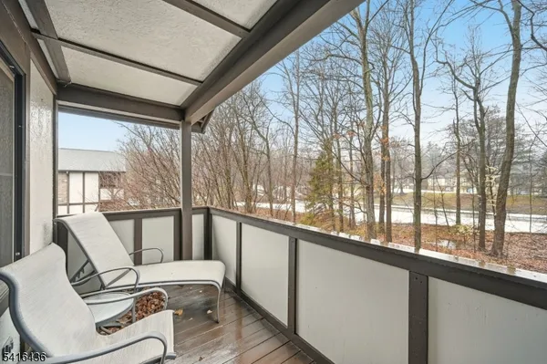 a view of a chairs and table in the balcony