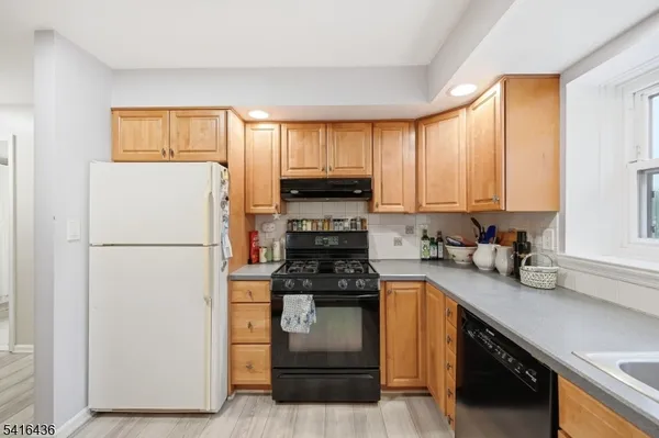 a kitchen with a refrigerator and a sink