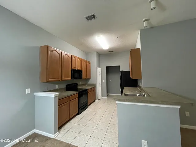 a kitchen with stainless steel appliances a stove microwave and a sink