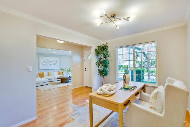 a living room with furniture and a chandelier