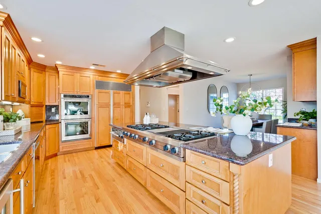 a kitchen with stainless steel appliances granite countertop a stove and a refrigerator