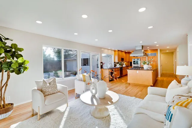 a living room with furniture kitchen and a table