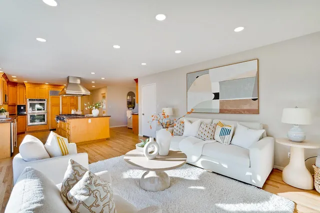 a living room with furniture and a floor to ceiling window