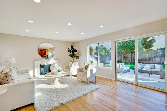 a living room with fireplace furniture and a wooden floor