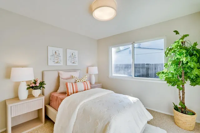 a bedroom with a bed and a night stand