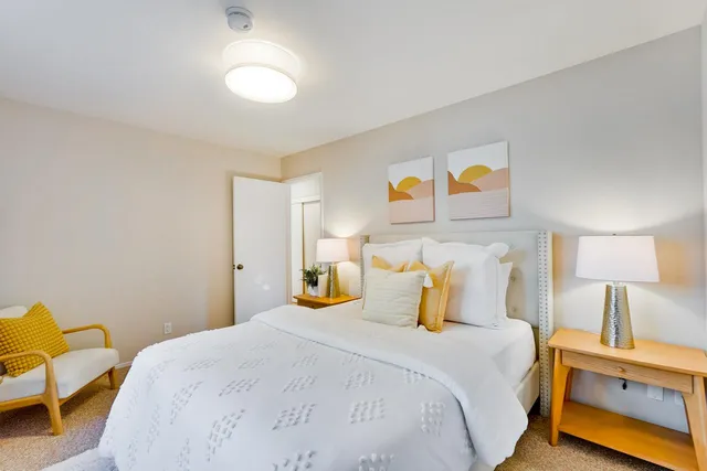 a bedroom with a bed and chair