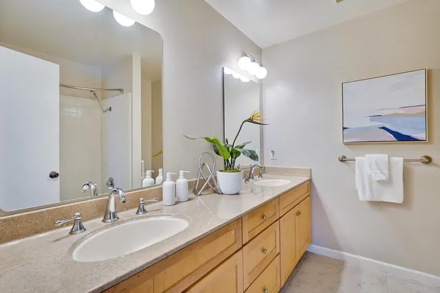 a bathroom with a double vanity sink and a mirror