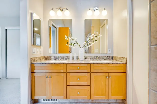 a living room with furniture and flowers