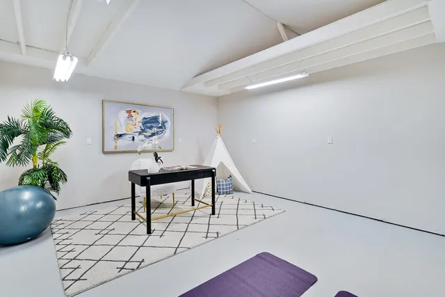 a patio with couches and a fire pit