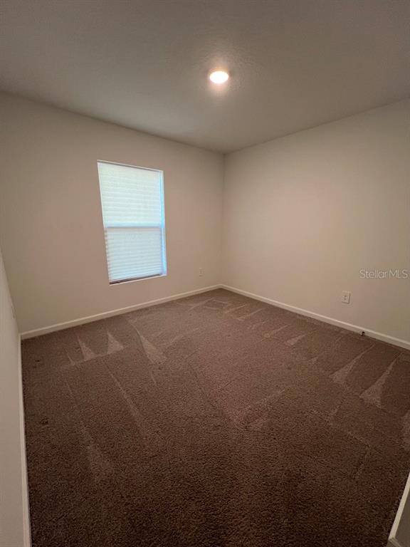 9131 Swiss Road Spring Hill, FL 34606 - Photo 13 of 16 an empty room with a window
