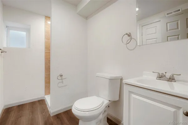 a bathroom with a sink toilet and a mirror