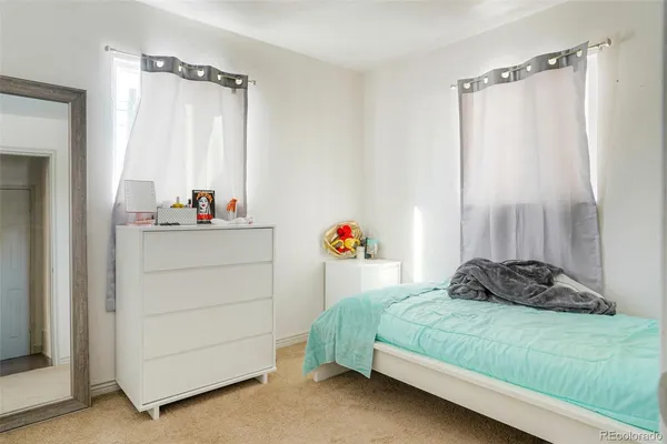a bedroom with a bed and a dresser