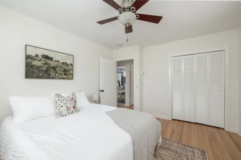 a bedroom with a large bed and a chandelier