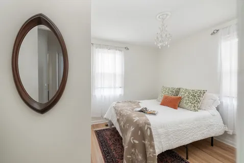 a bedroom with a bed and a mirror