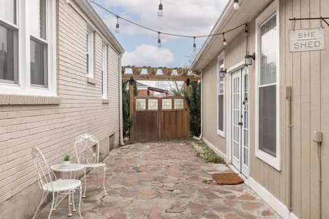 a view of a porch with a table and chairs