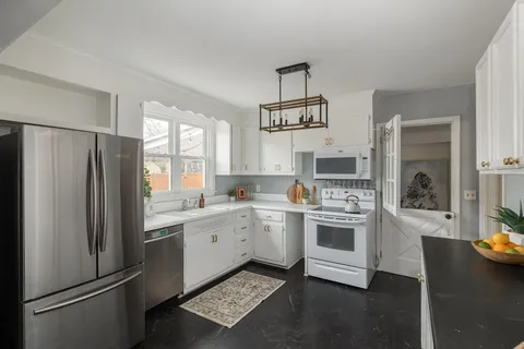 a kitchen with stainless steel appliances a refrigerator sink and stove