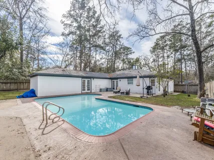 a view of a house with swimming pool and sitting area