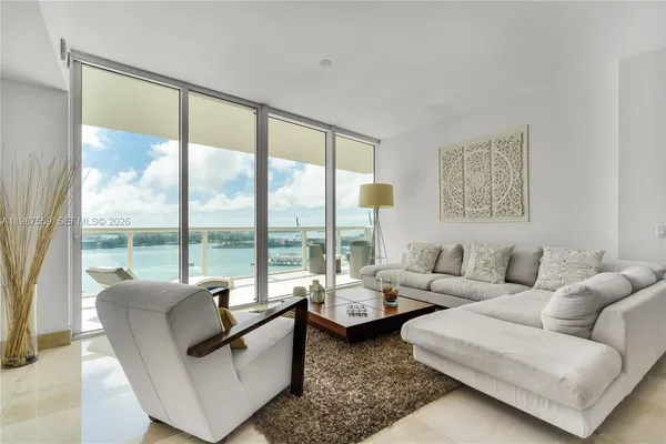 a living room with furniture and a large window