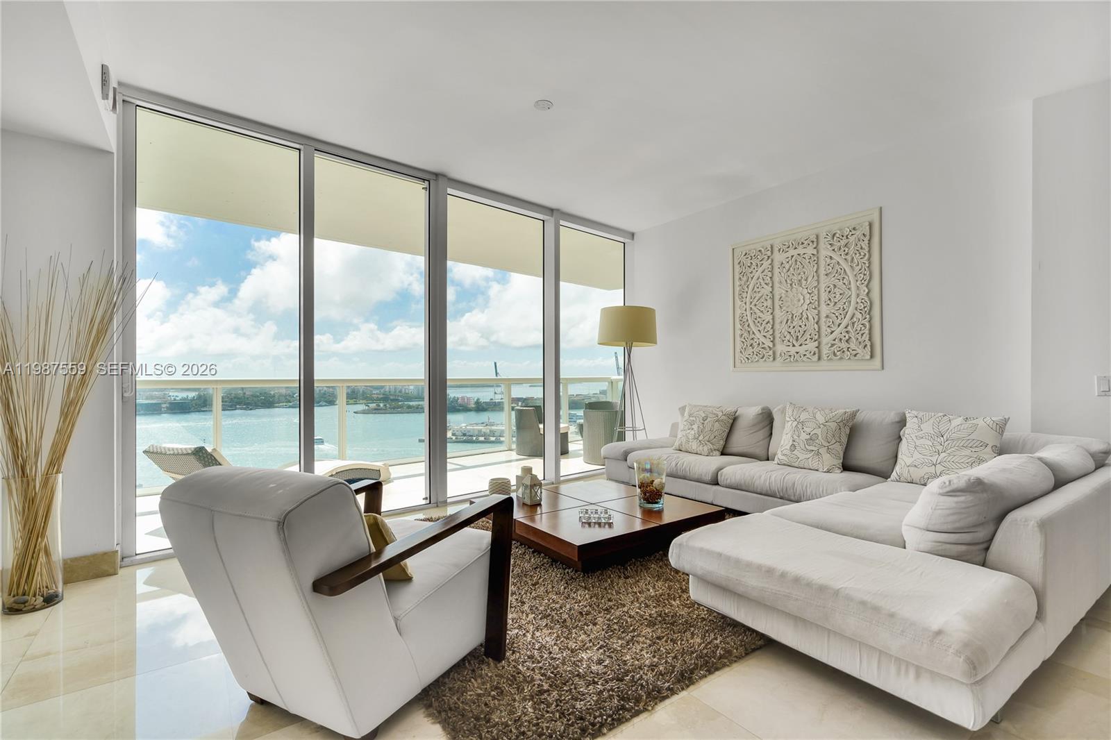 450 Alton Road, Unit 2005 Miami Beach, FL 33139 - Photo 11 of 19 a living room with furniture and a floor to ceiling window