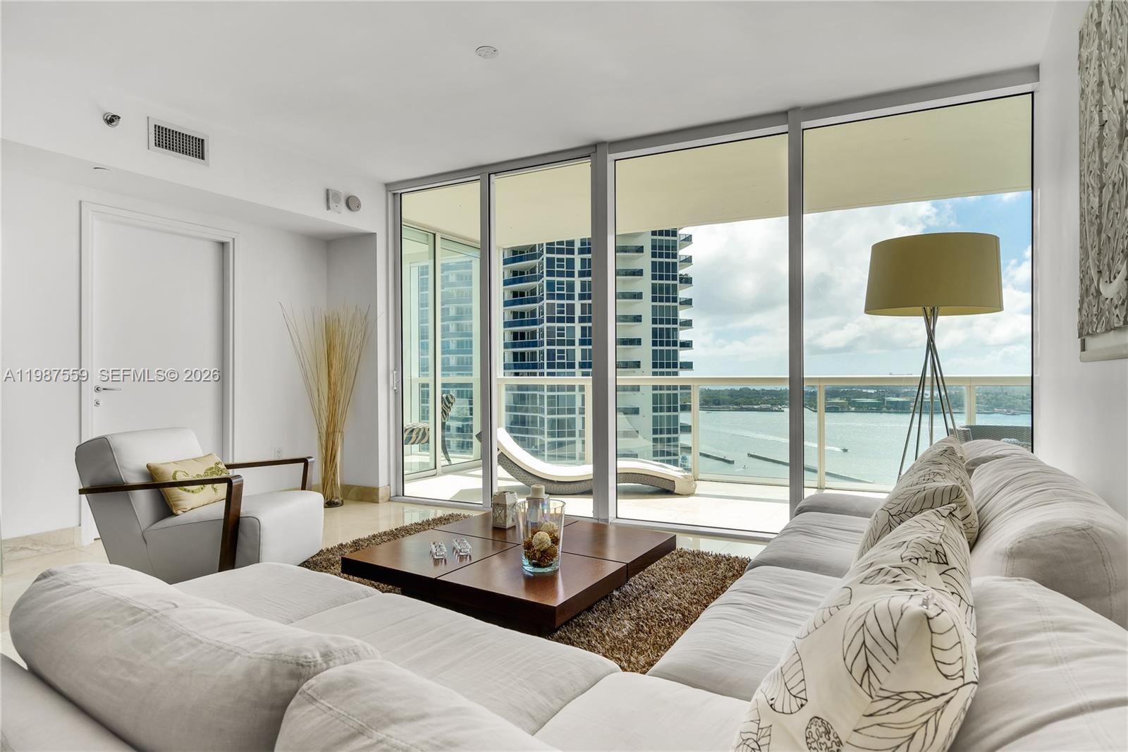 450 Alton Road, Unit 2005 Miami Beach, FL 33139 - Photo 12 of 19 a living room with furniture and a large window