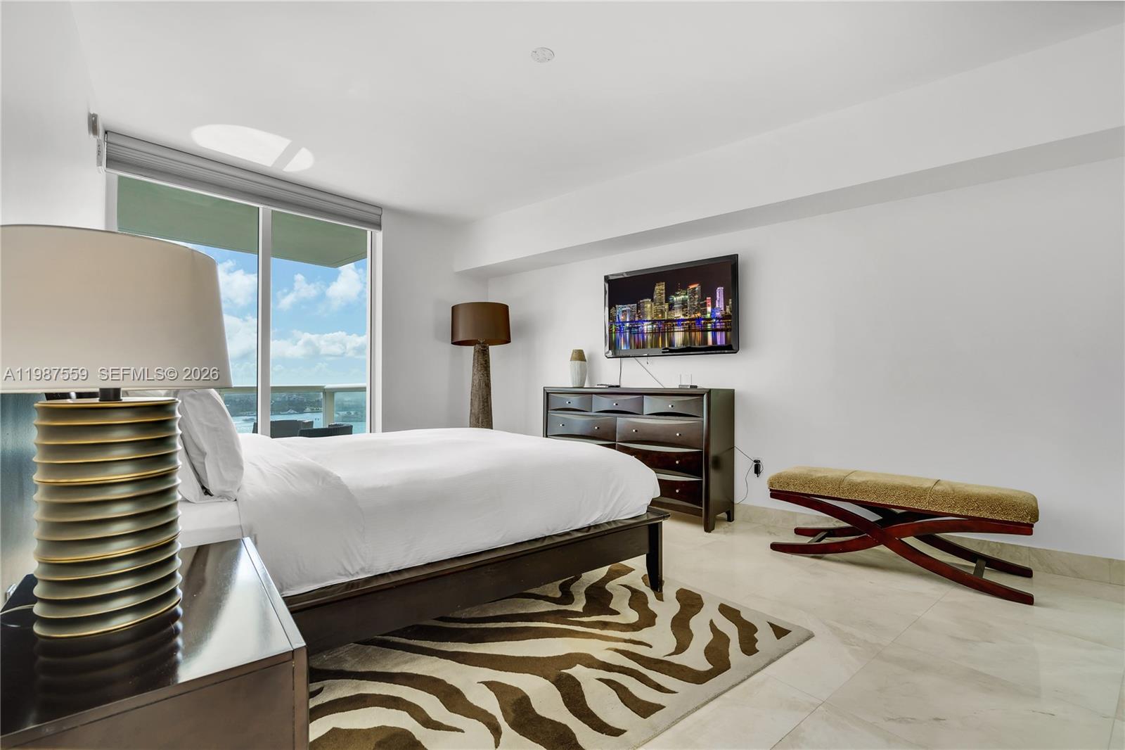 450 Alton Road, Unit 2005 Miami Beach, FL 33139 - Photo 13 of 19 a room with a bed and a table