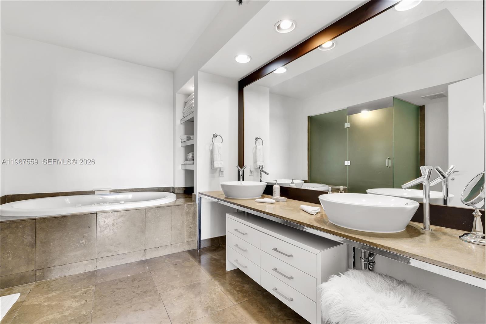 450 Alton Road, Unit 2005 Miami Beach, FL 33139 - Photo 14 of 19 a bathroom with a granite countertop sink mirror and bathtub