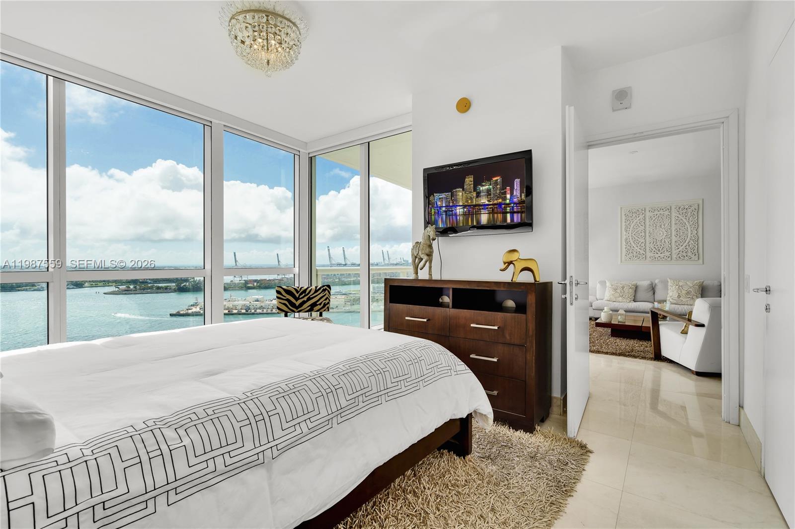 450 Alton Road, Unit 2005 Miami Beach, FL 33139 - Photo 15 of 19 a bedroom with a bed and a large window