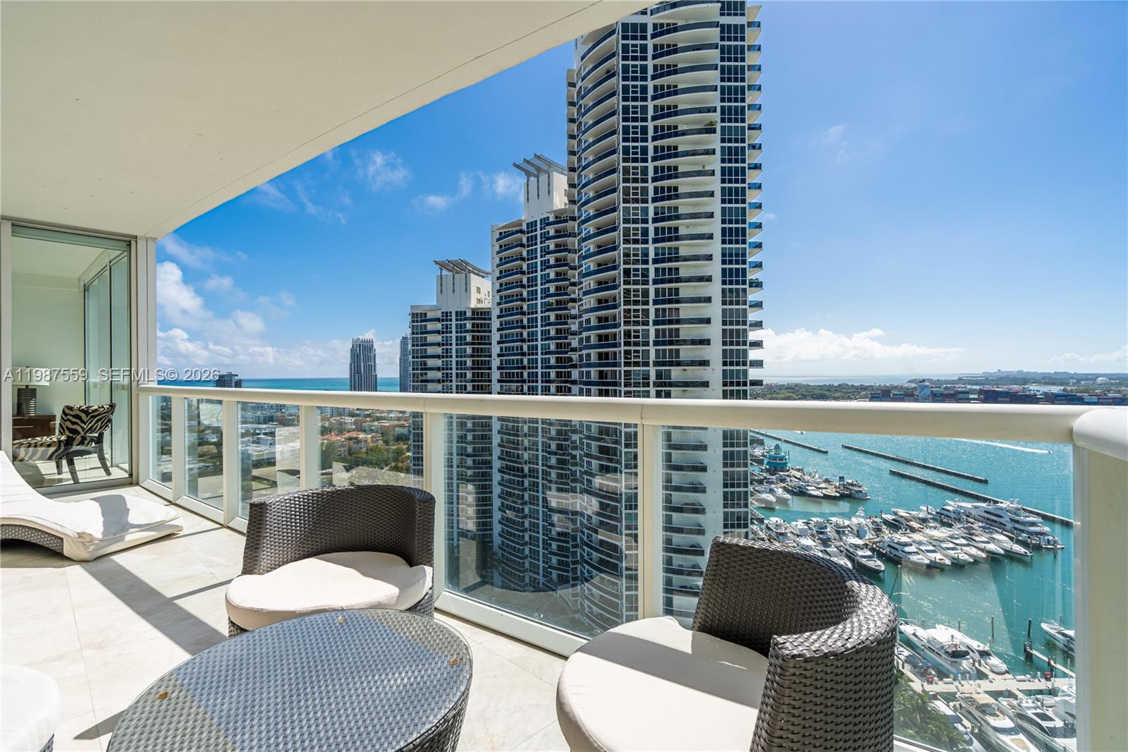 450 Alton Road, Unit 2005 Miami Beach, FL 33139 - Photo 17 of 19 a balcony with furniture and a potted plant