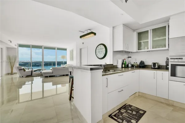 a kitchen with stainless steel appliances granite countertop a refrigerator and a stove