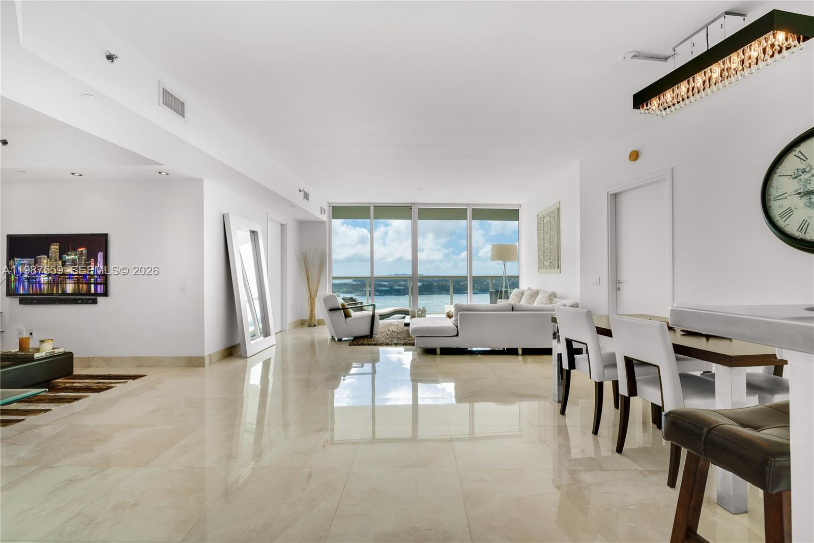 450 Alton Road, Unit 2005 Miami Beach, FL 33139 - Photo 8 of 19 a living room with furniture and a flat screen tv