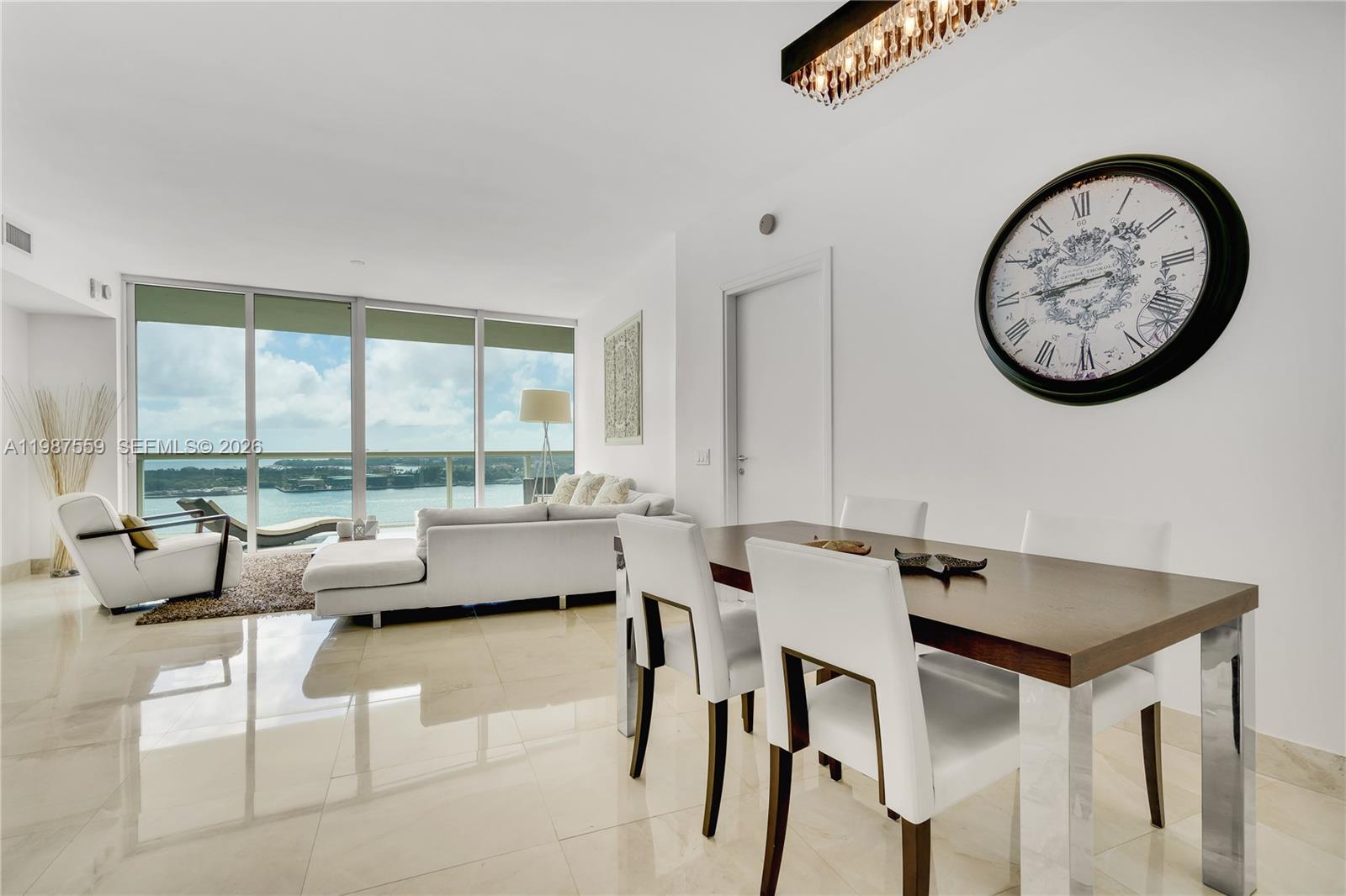 450 Alton Road, Unit 2005 Miami Beach, FL 33139 - Photo 9 of 19 a view of a livingroom with furniture and window