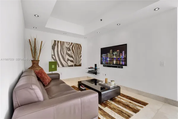 a living room with furniture and a floor to ceiling window