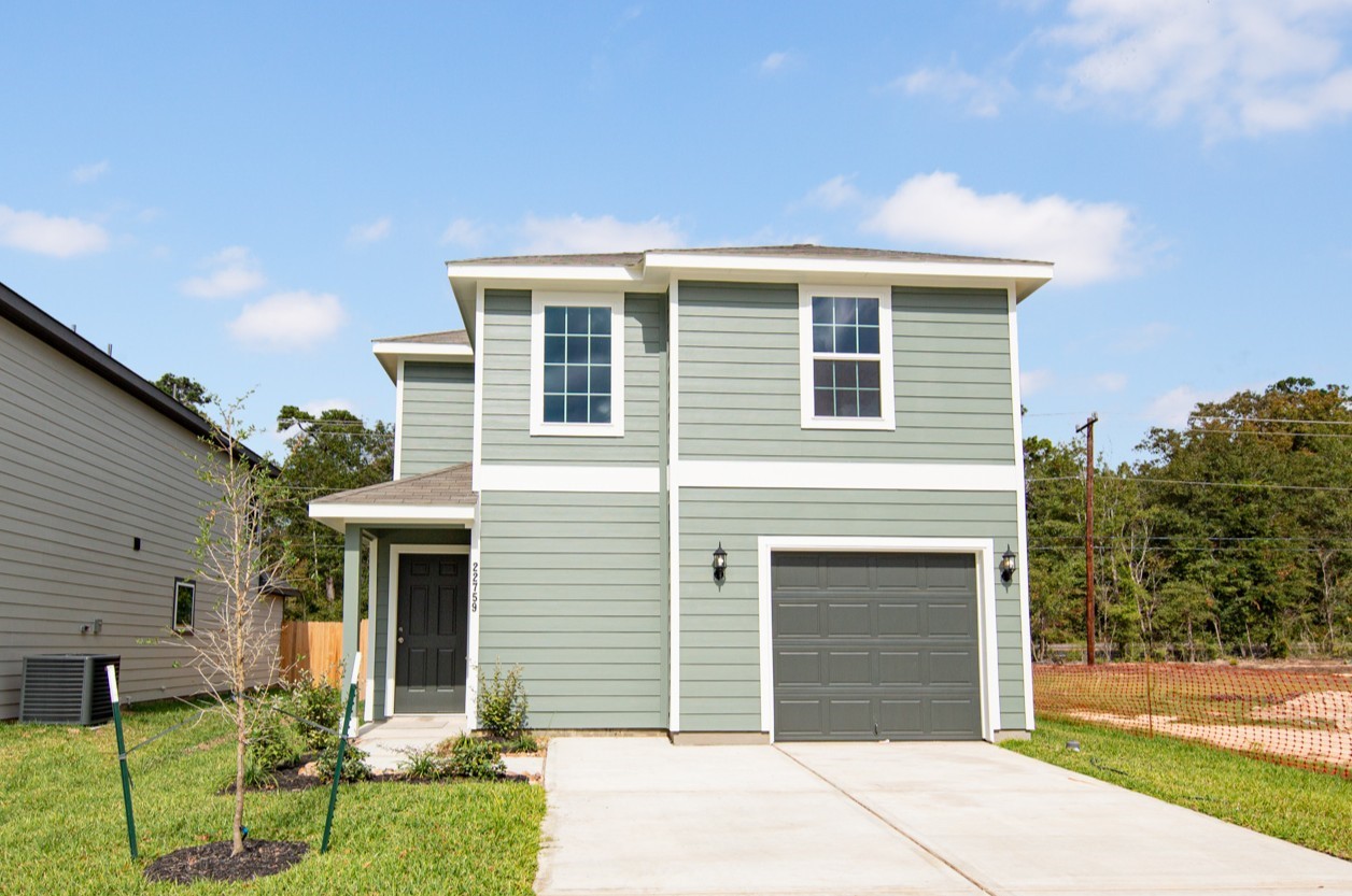 22759 American Kestrel Court Splendora, TX 77372 - Photo 1 of 23 a front view of a house with a yard